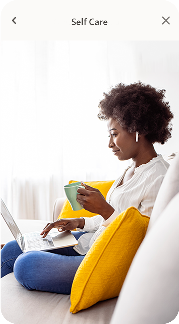 self-care Woman sitting with coffee mug and laptop on couch